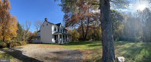 view of side of home with a yard