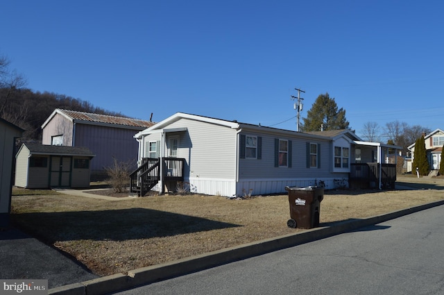 view of front facade featuring a storage unit and an outdoor structure