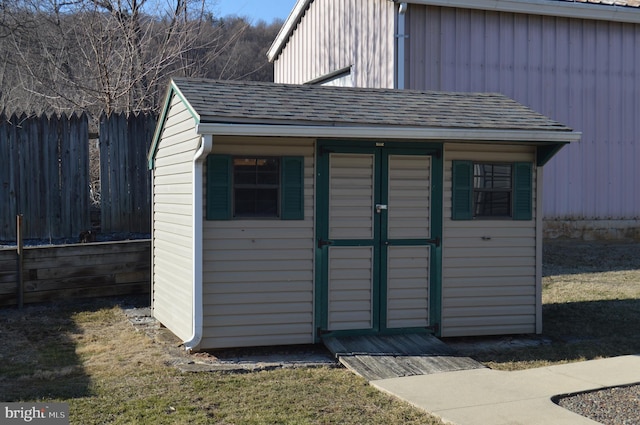 view of shed featuring fence