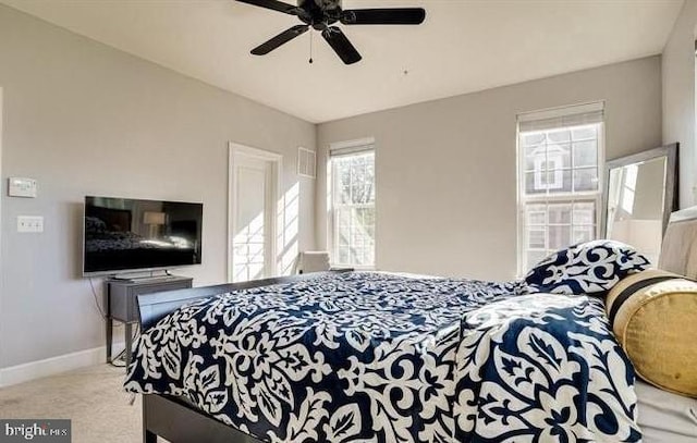 carpeted bedroom featuring a ceiling fan and baseboards