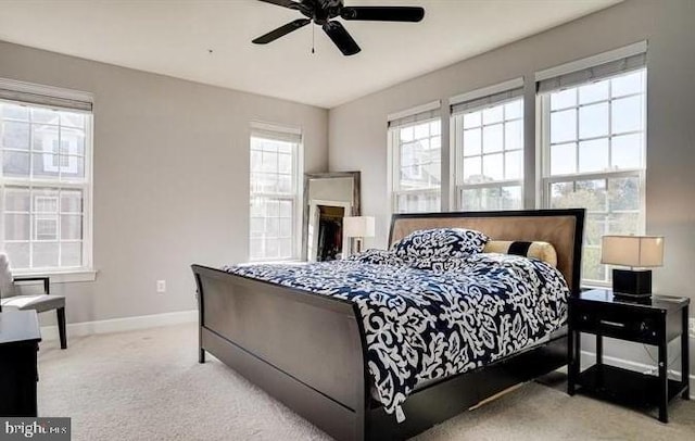 carpeted bedroom featuring ceiling fan and baseboards