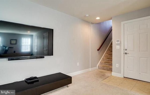 interior space with light tile patterned floors, baseboards, light colored carpet, stairway, and recessed lighting