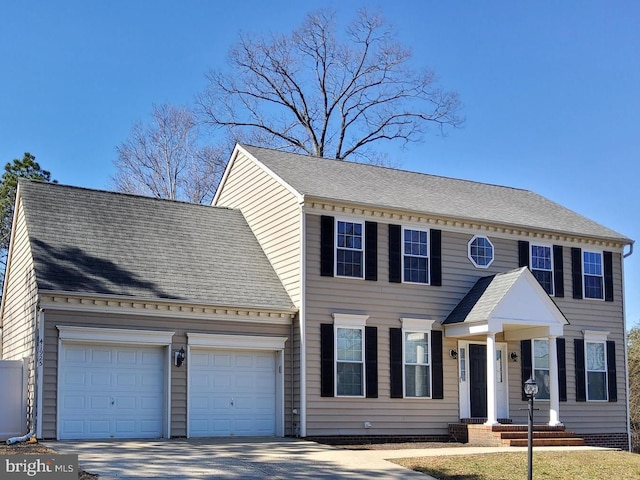 view of front of home featuring a garage, concrete driveway, and a shingled roof