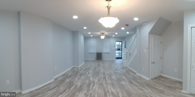 interior space with light wood-style floors, recessed lighting, baseboards, and stairs