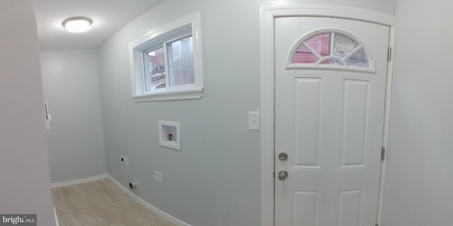 laundry area with light wood-style flooring, hookup for an electric dryer, laundry area, washer hookup, and baseboards