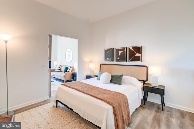 bedroom featuring baseboards and wood finished floors