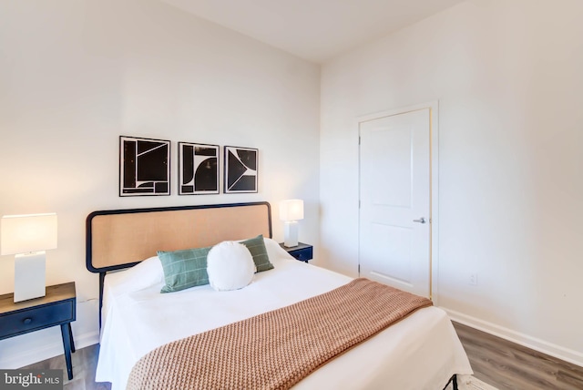 bedroom featuring wood finished floors and baseboards