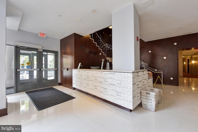 reception featuring stairway and french doors