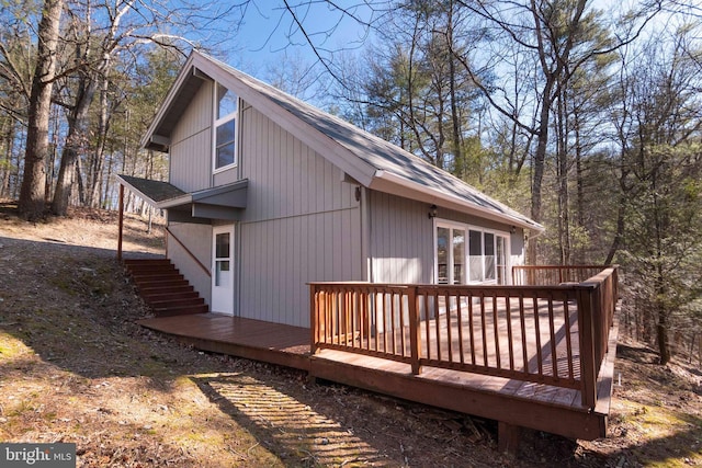 view of property exterior featuring a wooden deck