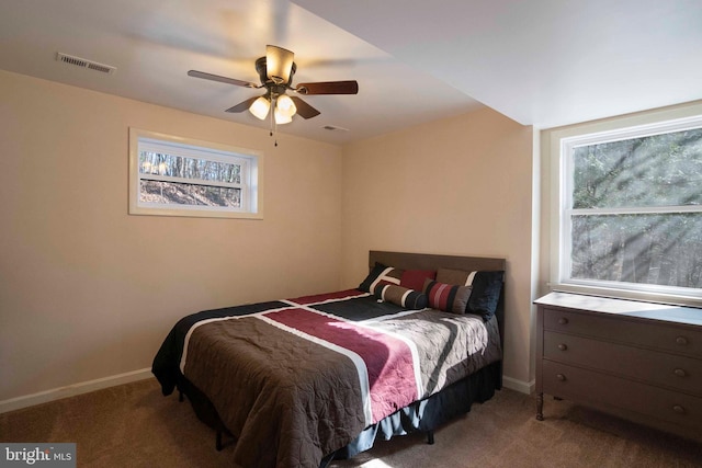 carpeted bedroom with visible vents, ceiling fan, and baseboards