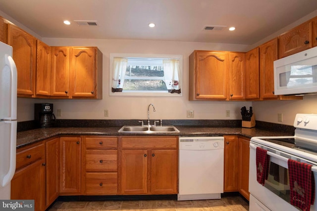 kitchen featuring white appliances, visible vents, a sink, and recessed lighting