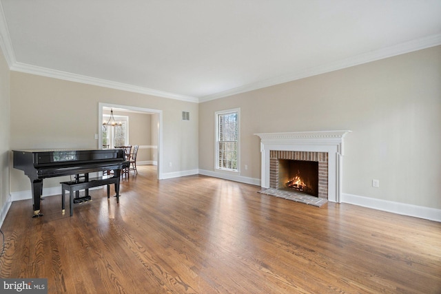 living room featuring plenty of natural light, wood finished floors, and a brick fireplace