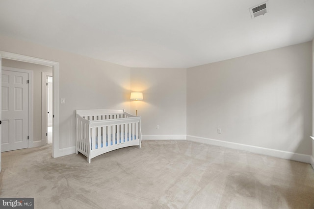 unfurnished bedroom with carpet floors, visible vents, and baseboards