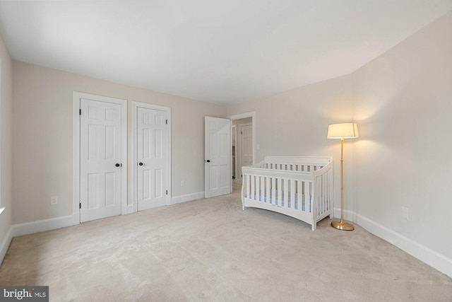 unfurnished bedroom featuring carpet flooring and baseboards