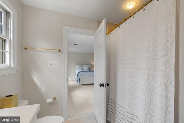 full bathroom with a shower with curtain, vanity, toilet, and tile patterned floors