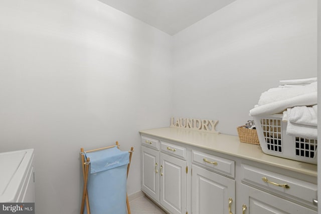 bathroom featuring toilet, washing machine and dryer, and tile patterned flooring