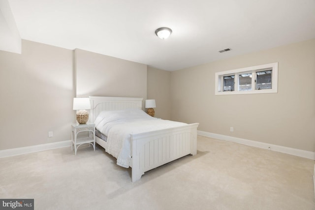 bedroom with light colored carpet, visible vents, and baseboards