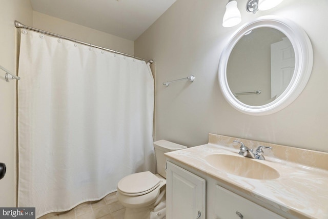 full bathroom with toilet, vanity, and tile patterned floors