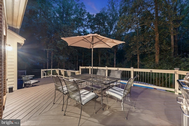 wooden deck featuring outdoor dining area