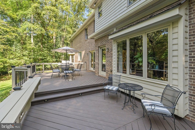 wooden terrace with outdoor dining area