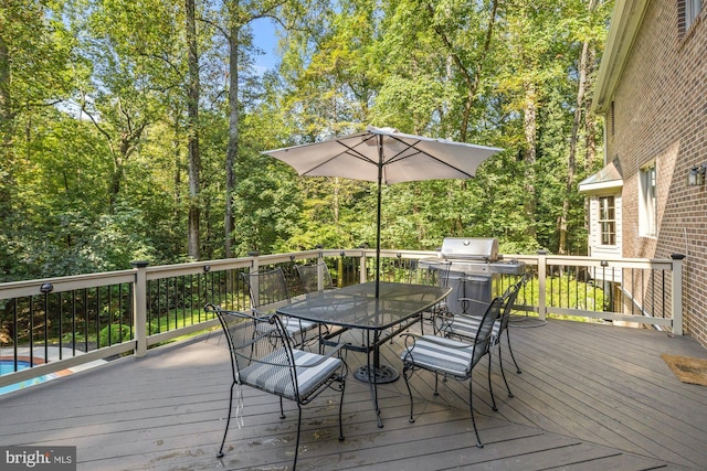 deck with area for grilling and outdoor dining space