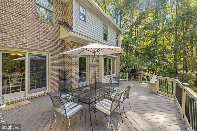 wooden terrace featuring outdoor dining space