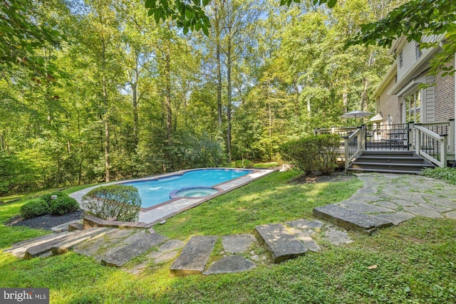 view of pool with a pool with connected hot tub, a lawn, and a deck