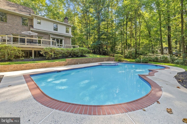 view of pool featuring a pool with connected hot tub and a wooden deck