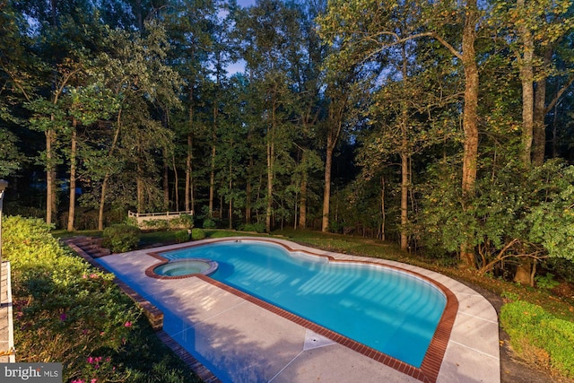 view of pool with a pool with connected hot tub