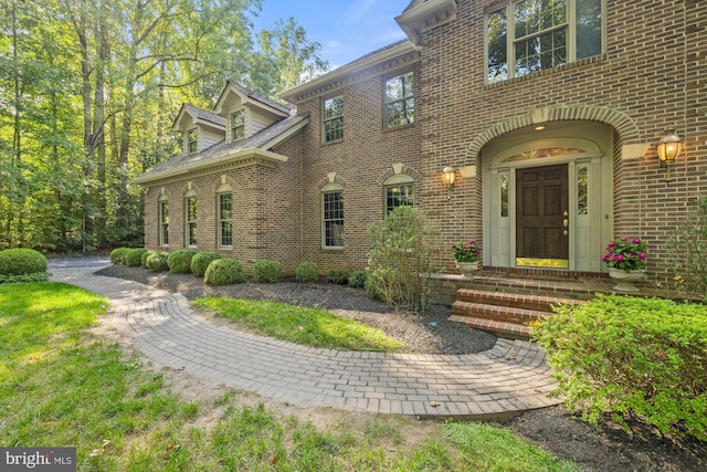 property entrance with brick siding