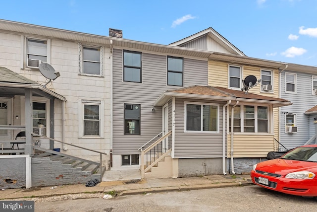 townhome / multi-family property with entry steps and a chimney