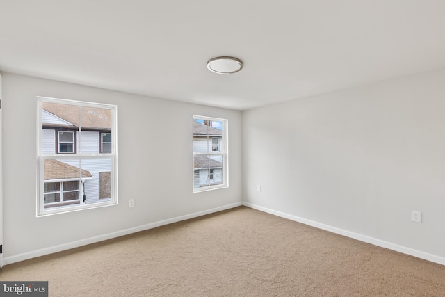 empty room with carpet and baseboards