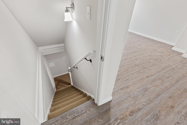 stairway featuring baseboards and wood finished floors