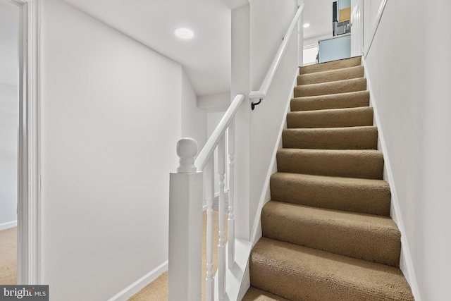 stairway featuring recessed lighting and baseboards