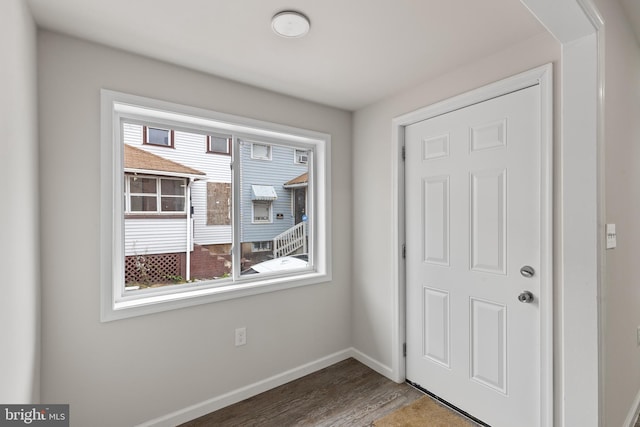 entryway with wood finished floors and baseboards