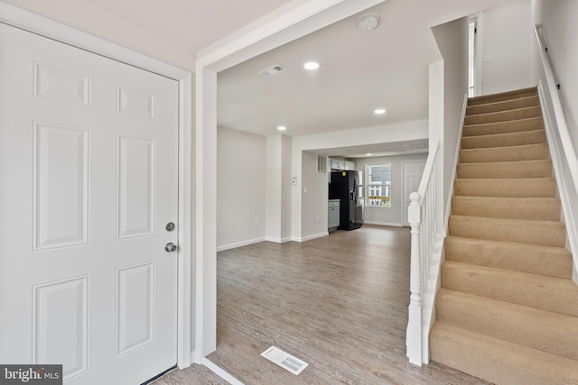 entrance foyer with recessed lighting, wood finished floors, visible vents, baseboards, and stairway