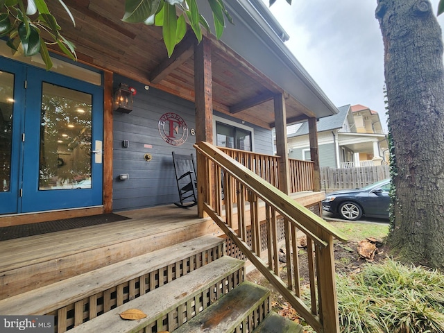 view of exterior entry with a porch