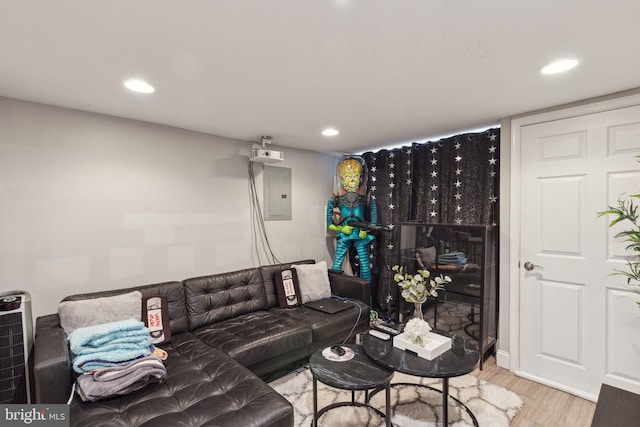 living area featuring electric panel, wood finished floors, and recessed lighting