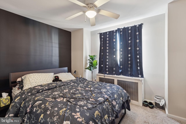 carpeted bedroom with ceiling fan and baseboards