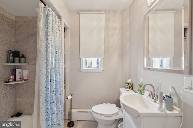 bathroom featuring baseboard heating, vanity, and toilet