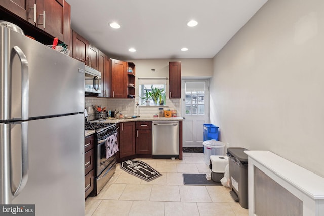 kitchen featuring light tile patterned floors, light stone counters, stainless steel appliances, open shelves, and backsplash