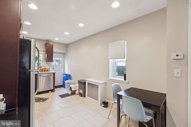 kitchen featuring light tile patterned floors, recessed lighting, stainless steel appliances, baseboards, and light countertops