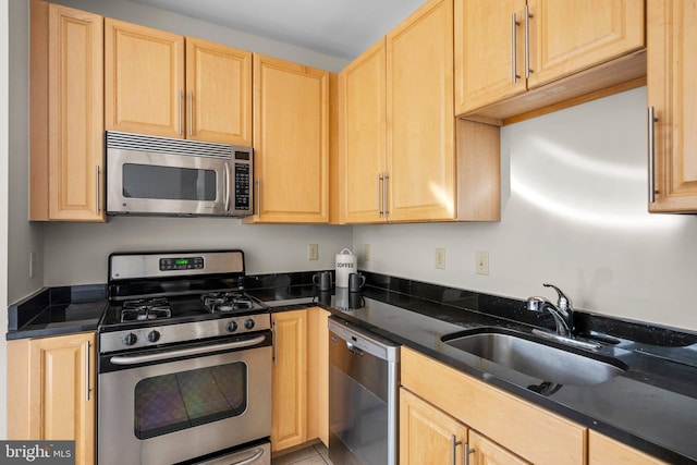 kitchen featuring a sink, stainless steel appliances, and light brown cabinets