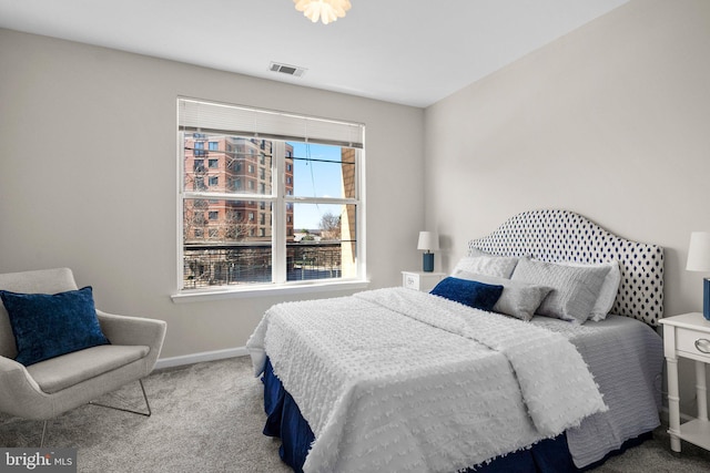 carpeted bedroom featuring baseboards and visible vents