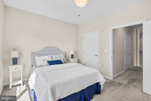 carpeted bedroom featuring baseboards