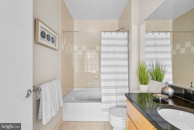 bathroom featuring tile patterned floors, shower / bathtub combination with curtain, toilet, and vanity