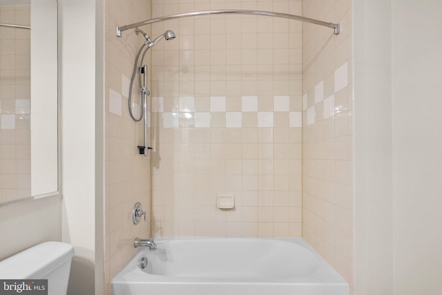 bathroom featuring tub / shower combination and toilet