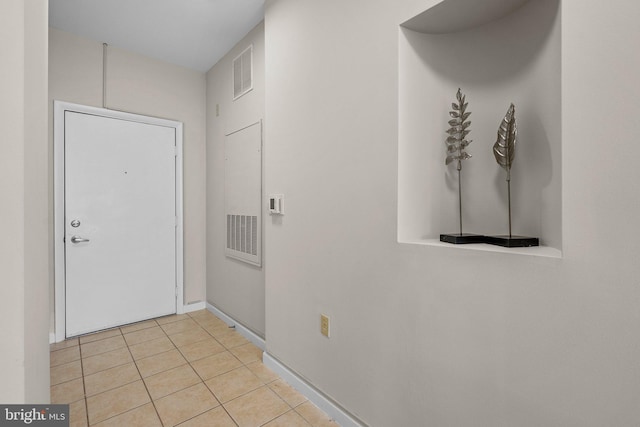 entryway with light tile patterned flooring, baseboards, and visible vents