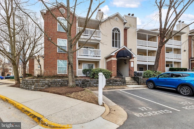 view of property featuring uncovered parking