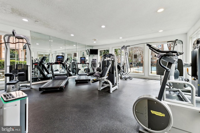 gym with a textured ceiling and recessed lighting